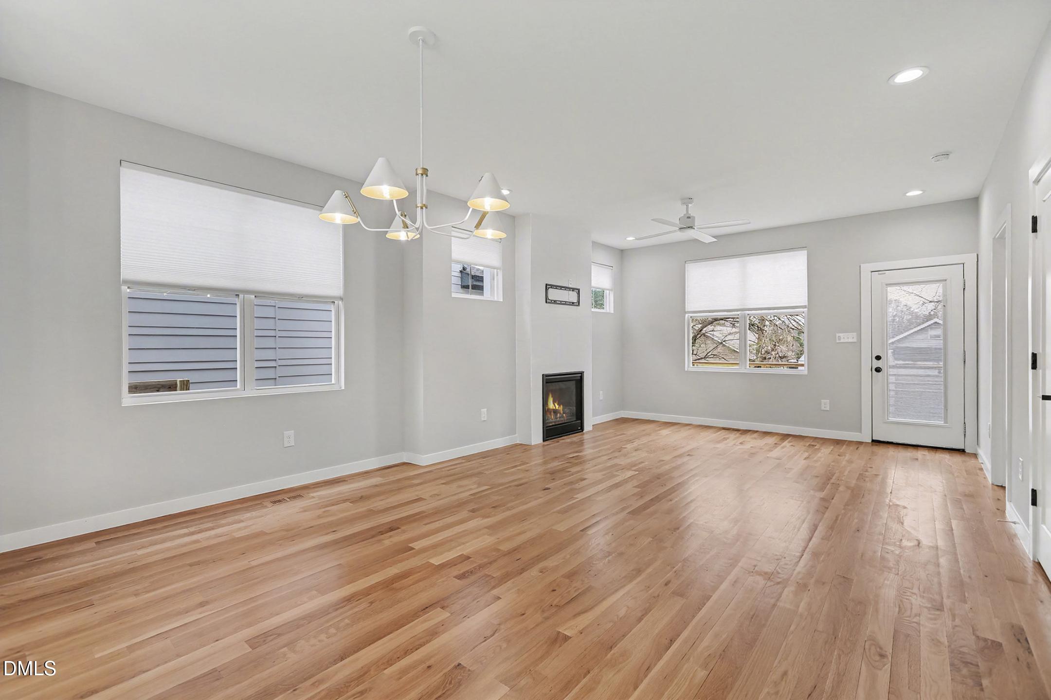 1508 East Jones Street Raleigh, NC 27610 - Photo 8 of 38 a view of an empty room with a window and wooden floor
