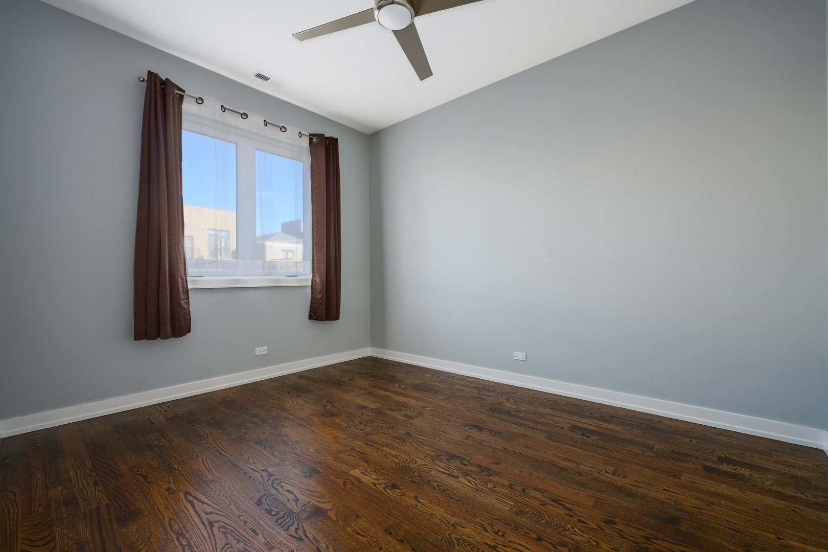 1832 West Rice Street, Unit 2 Chicago, IL 60622 - Photo 20 of 29 a view of an empty room with wooden floor and a window
