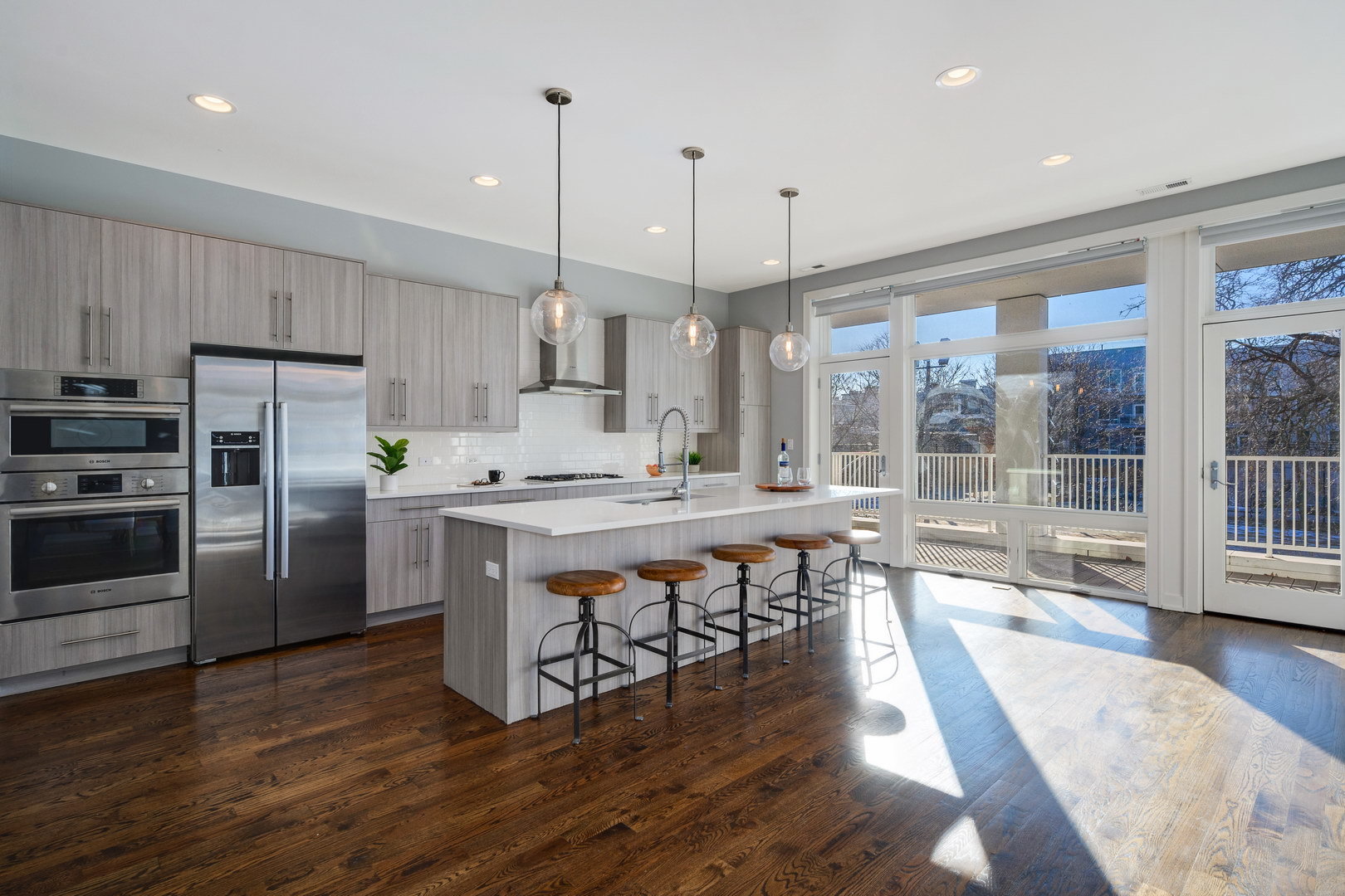 1832 West Rice Street, Unit 2 Chicago, IL 60622 - Photo 3 of 29 a kitchen with stainless steel appliances a stove a sink a refrigerator a center island and a wooden floor
