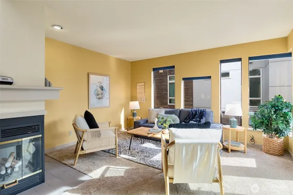 a dining room with furniture and a potted plant