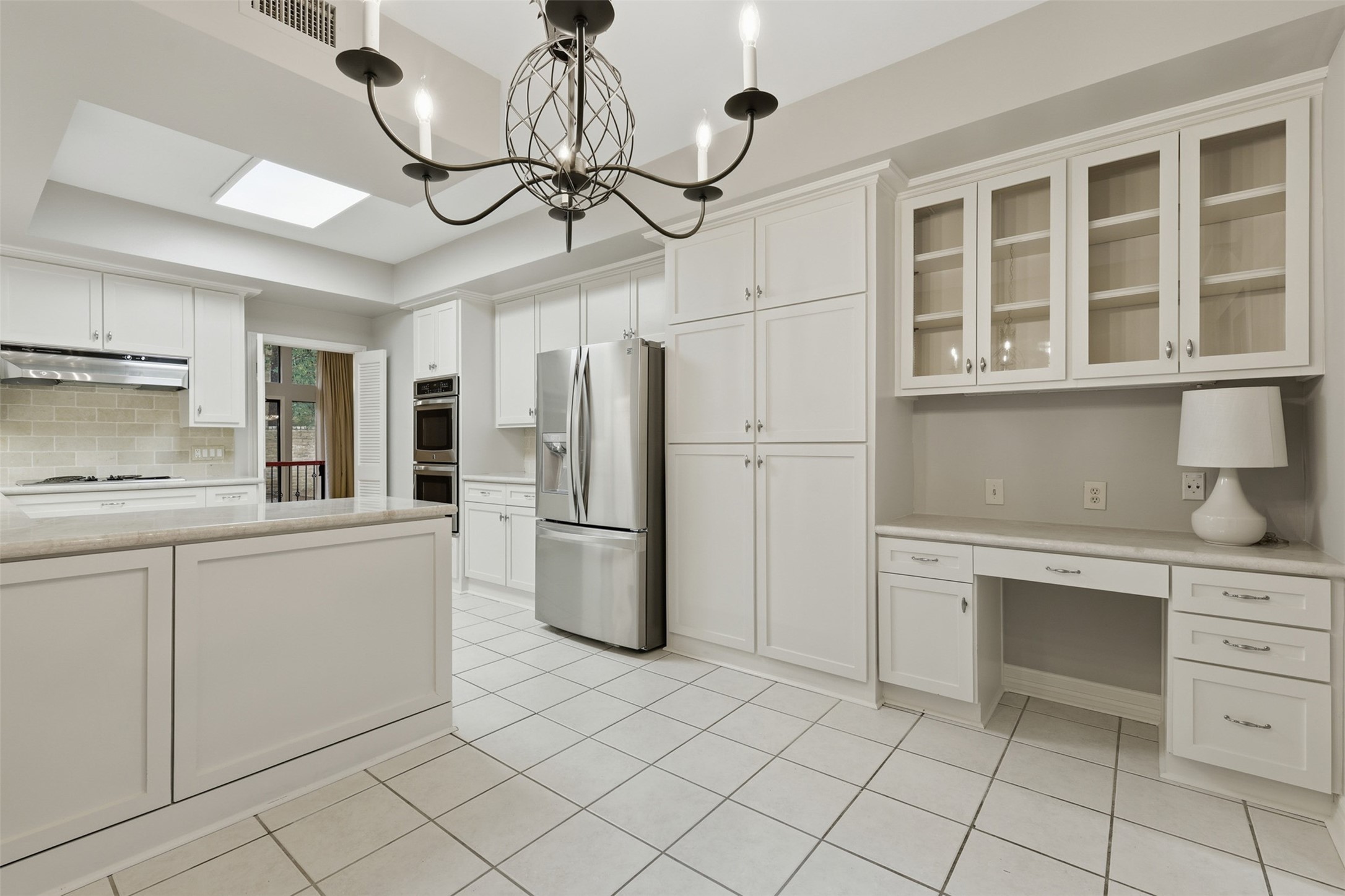 201 Vanderpool Lane, Unit 122 Houston, TX 77024 - Photo 12 of 35 a kitchen with cabinets and stainless steel appliances