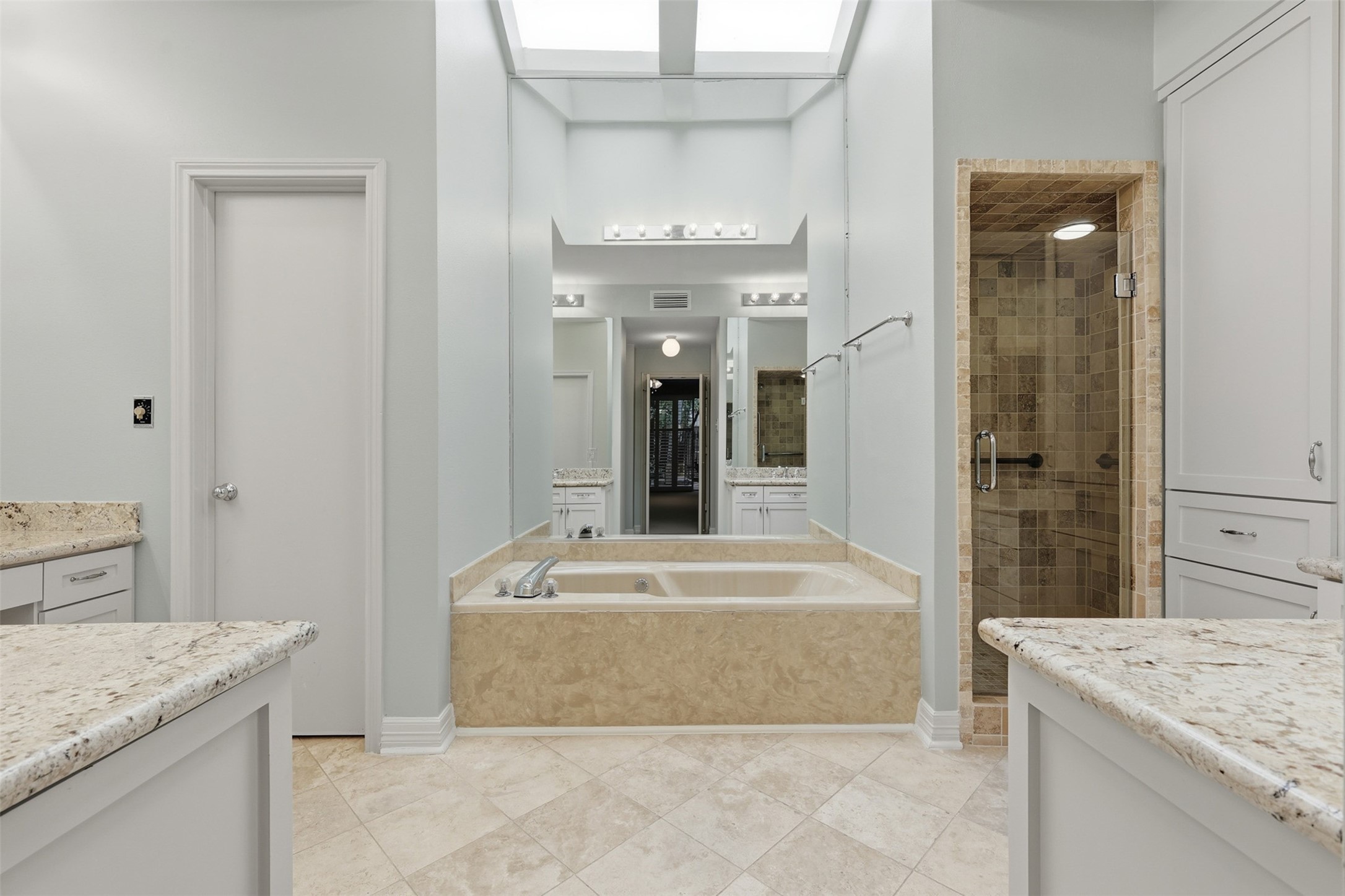 201 Vanderpool Lane, Unit 122 Houston, TX 77024 - Photo 16 of 35 a spacious bathroom with a granite countertop sink and a mirror