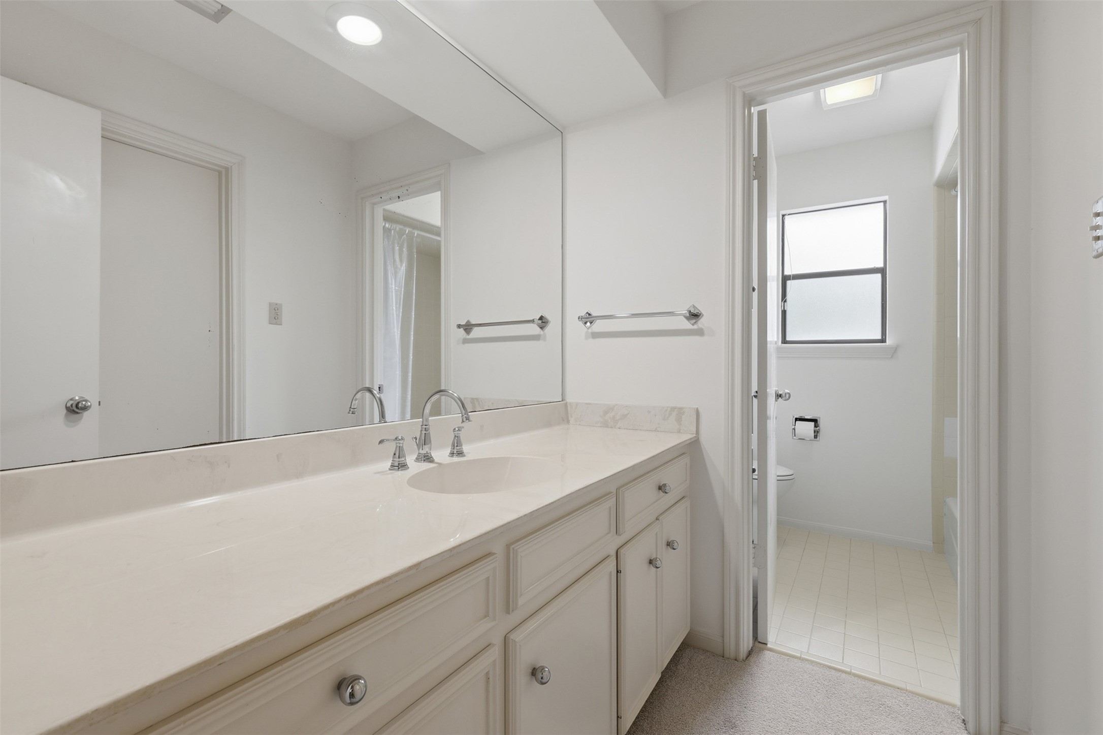 201 Vanderpool Lane, Unit 122 Houston, TX 77024 - Photo 21 of 35 a bathroom with a sink and a mirror