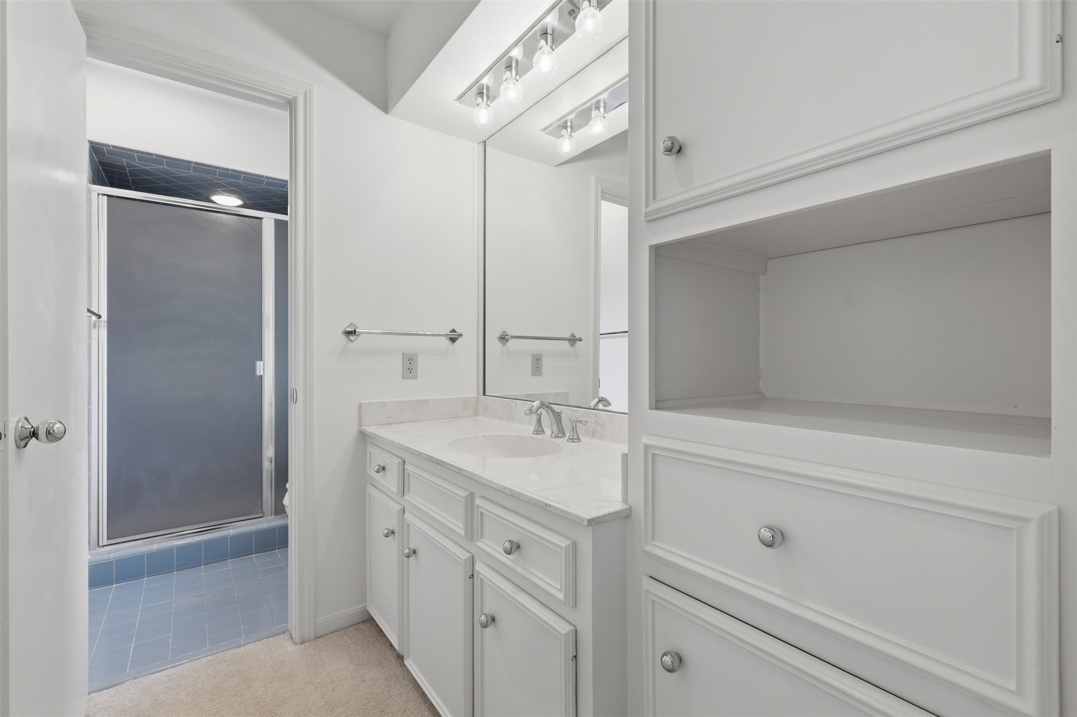 201 Vanderpool Lane, Unit 122 Houston, TX 77024 - Photo 24 of 35 a bathroom with a shower sink and mirror