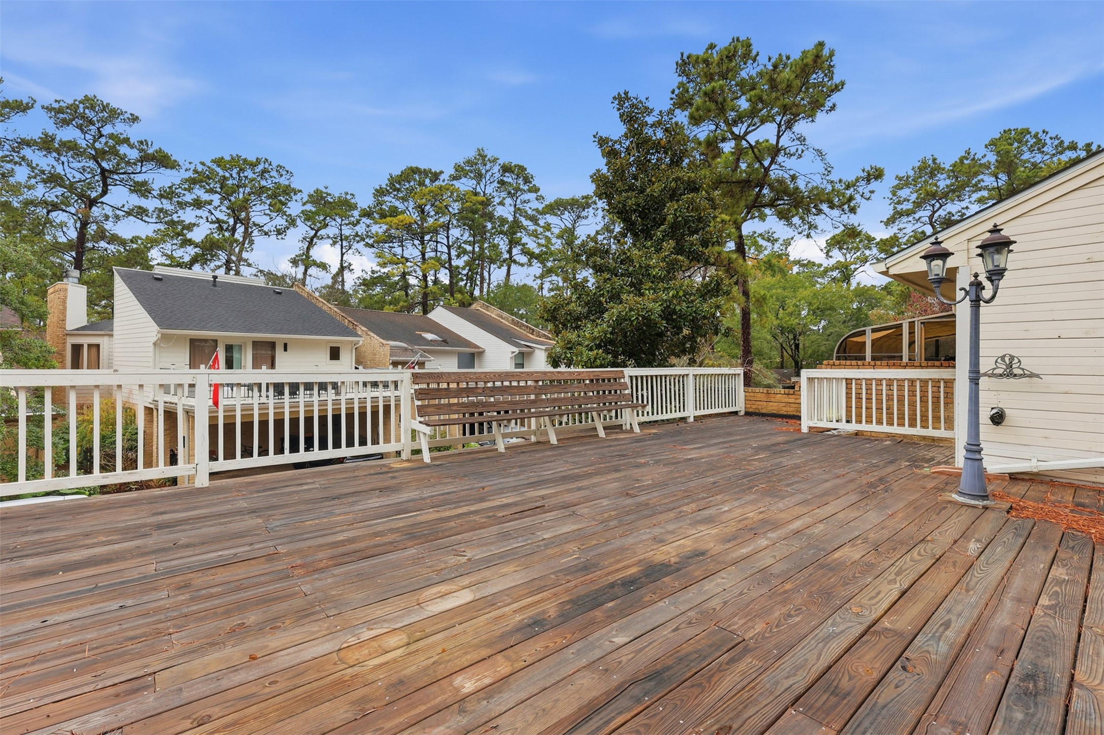 201 Vanderpool Lane, Unit 122 Houston, TX 77024 - Photo 25 of 35 a view of a deck and room with wooden floor and fence