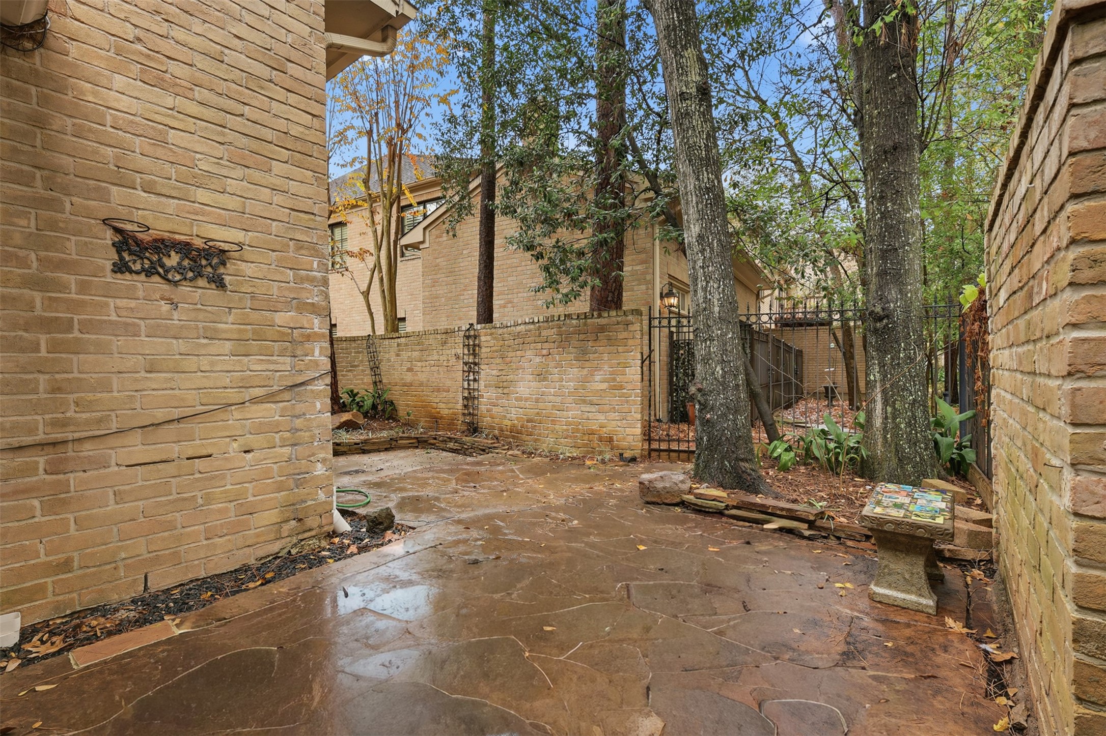 201 Vanderpool Lane, Unit 122 Houston, TX 77024 - Photo 28 of 35 a view of a brick house with a tree