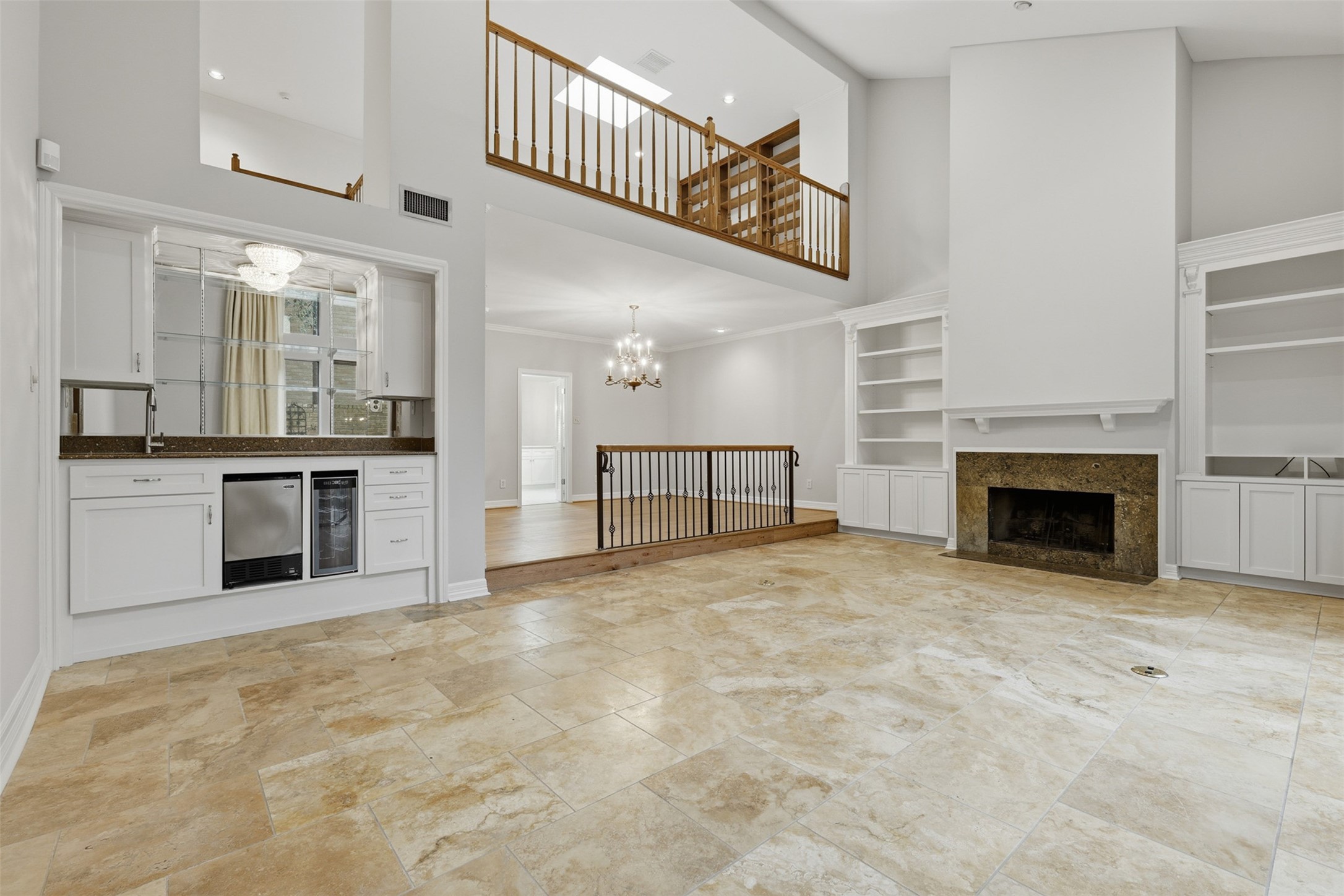 201 Vanderpool Lane, Unit 122 Houston, TX 77024 - Photo 8 of 35 a view of a kitchen with a sink and a fireplace