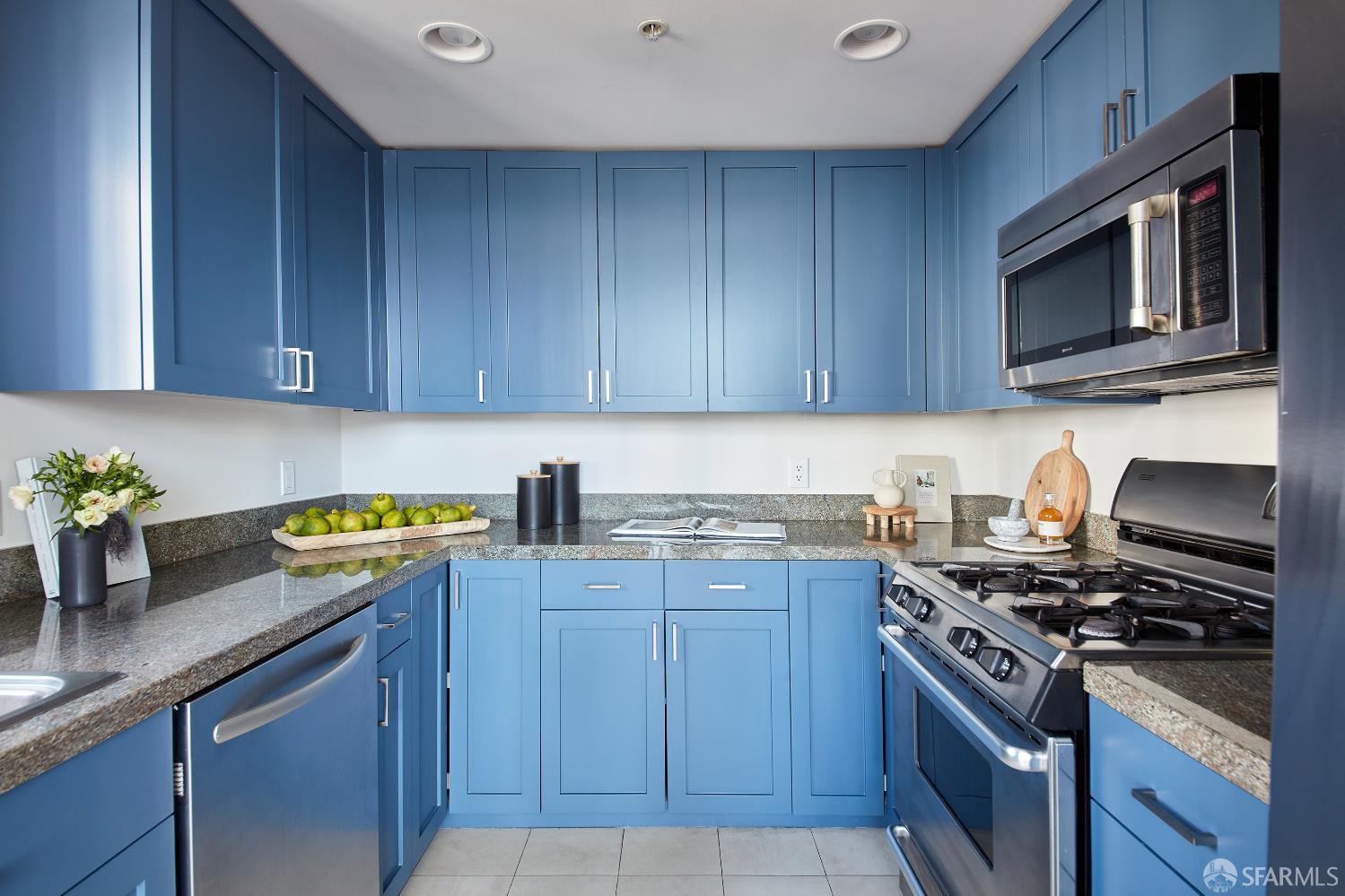 999 16th Street, Unit 11 San Francisco, CA 94107 - Photo 6 of 15 a kitchen with granite countertop a stove top oven a sink dishwasher and cabinets with wooden floor