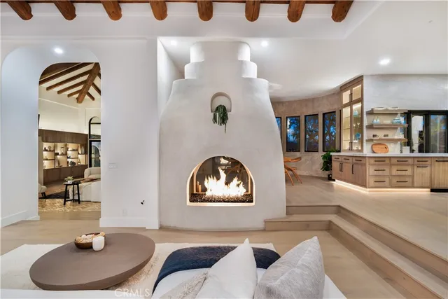 a dining room with furniture and large windows