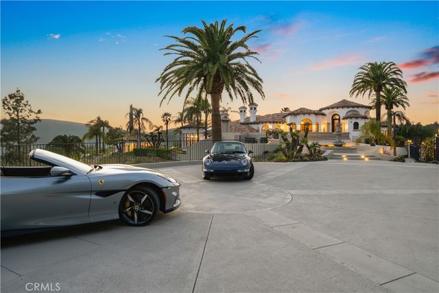 a view of a house with swimming pool and sitting area
