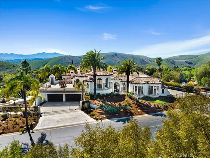 a view of a house with swimming pool and sitting area
