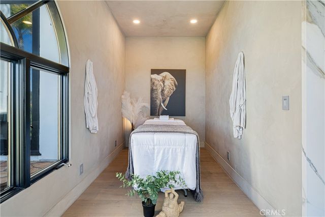 a roof deck with table and chairs under an umbrella with palm trees