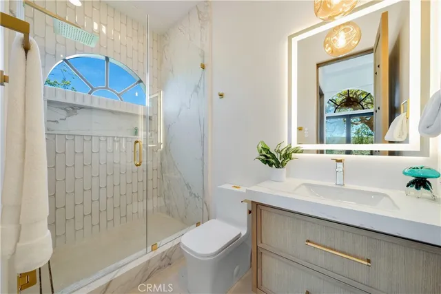 a front view of a house with a garden and trees