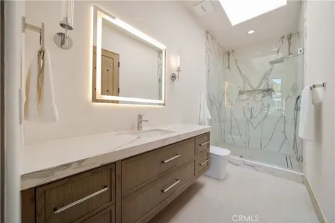 a roof deck with table and chairs under an umbrella with palm trees