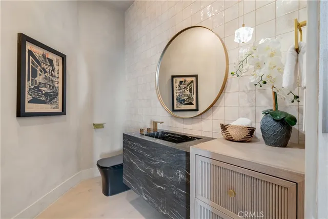 a view of entryway with paintings on the wall and a window