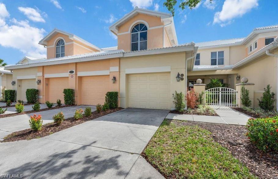 4680 Hawks Nest Way, Unit D103 Naples, FL 34114 - Photo 1 of 41 a front view of a house with garden