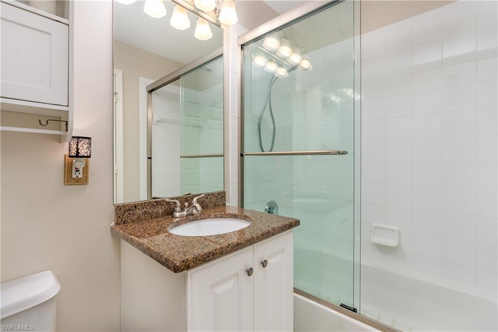 4680 Hawks Nest Way, Unit D103 Naples, FL 34114 - Photo 18 of 41 a bathroom with a sink and a mirror