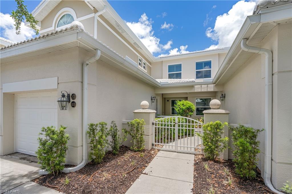 4680 Hawks Nest Way, Unit D103 Naples, FL 34114 - Photo 2 of 41 a front view of a house with a garden