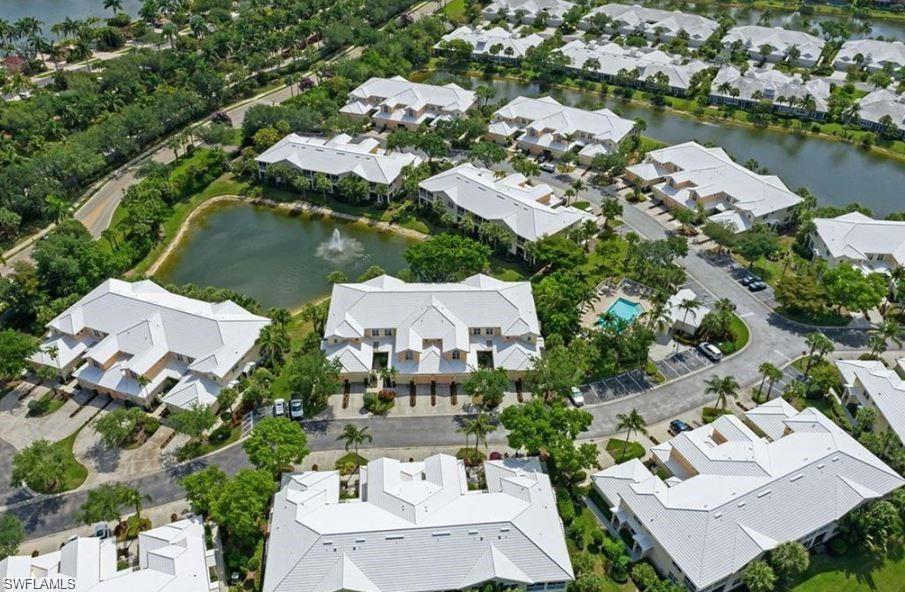 4680 Hawks Nest Way, Unit D103 Naples, FL 34114 - Photo 34 of 41 an aerial view of residential house with outdoor space and lake view