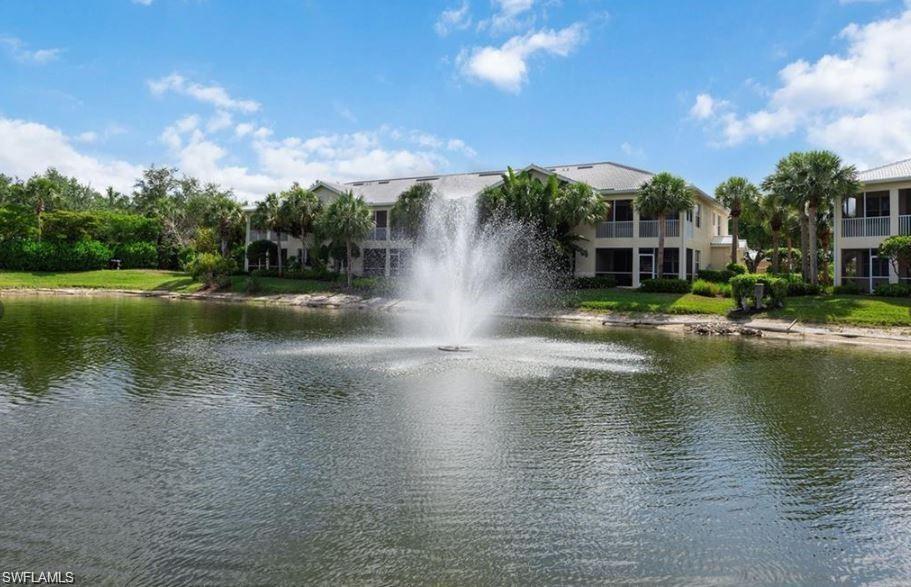 4680 Hawks Nest Way, Unit D103 Naples, FL 34114 - Photo 36 of 41 a view of pool with water fall and green space