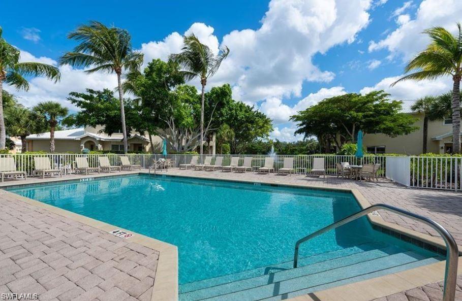 4680 Hawks Nest Way, Unit D103 Naples, FL 34114 - Photo 39 of 41 a view of a swimming pool with chairs