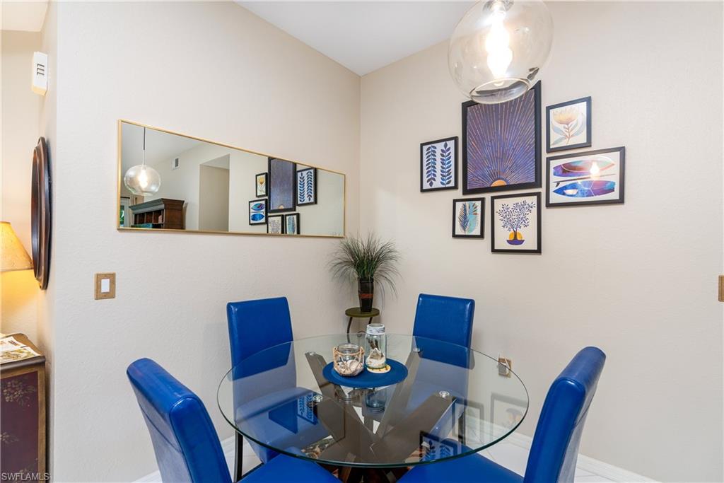 4680 Hawks Nest Way, Unit D103 Naples, FL 34114 - Photo 7 of 41 a view of a dining room with furniture