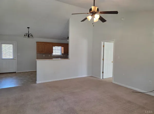 a view of a livingroom with a ceiling fan and window