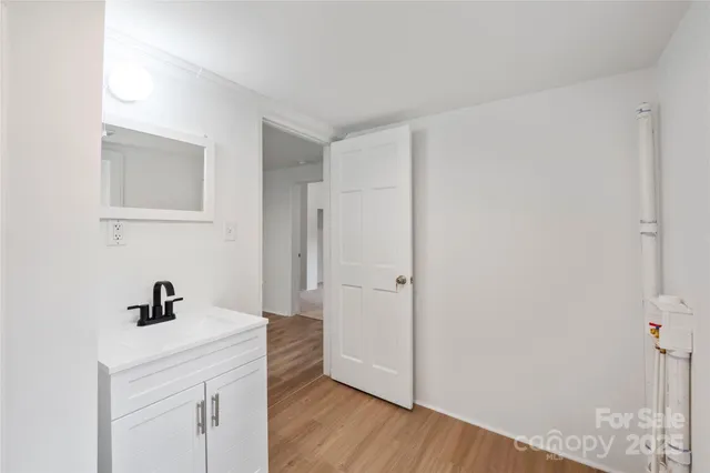 a view of hallway with wooden floor