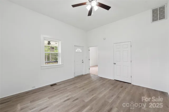 wooden floor in an empty room with a window