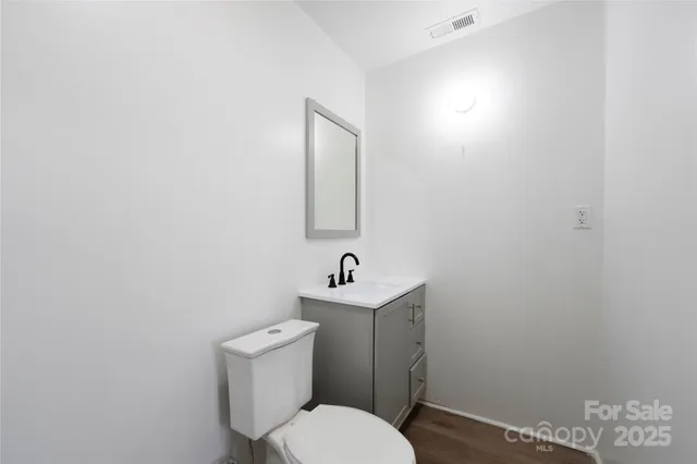 a white toilet sitting next to a bathroom sink