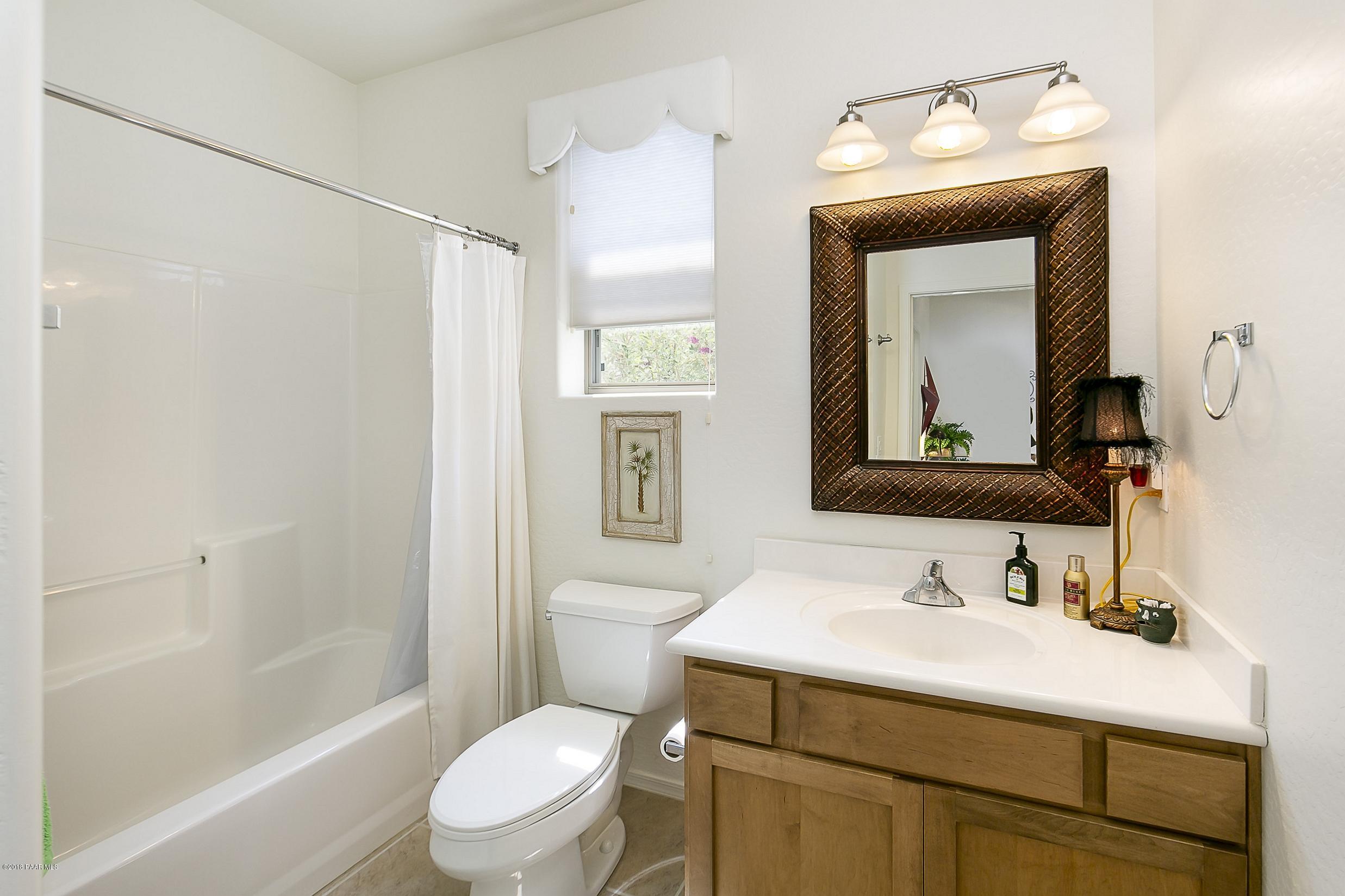 7106 Lynx Wagon Road Prescott Valley, AZ 86314 - Photo 12 of 26 a bathroom with a sink vanity mirror and toilet