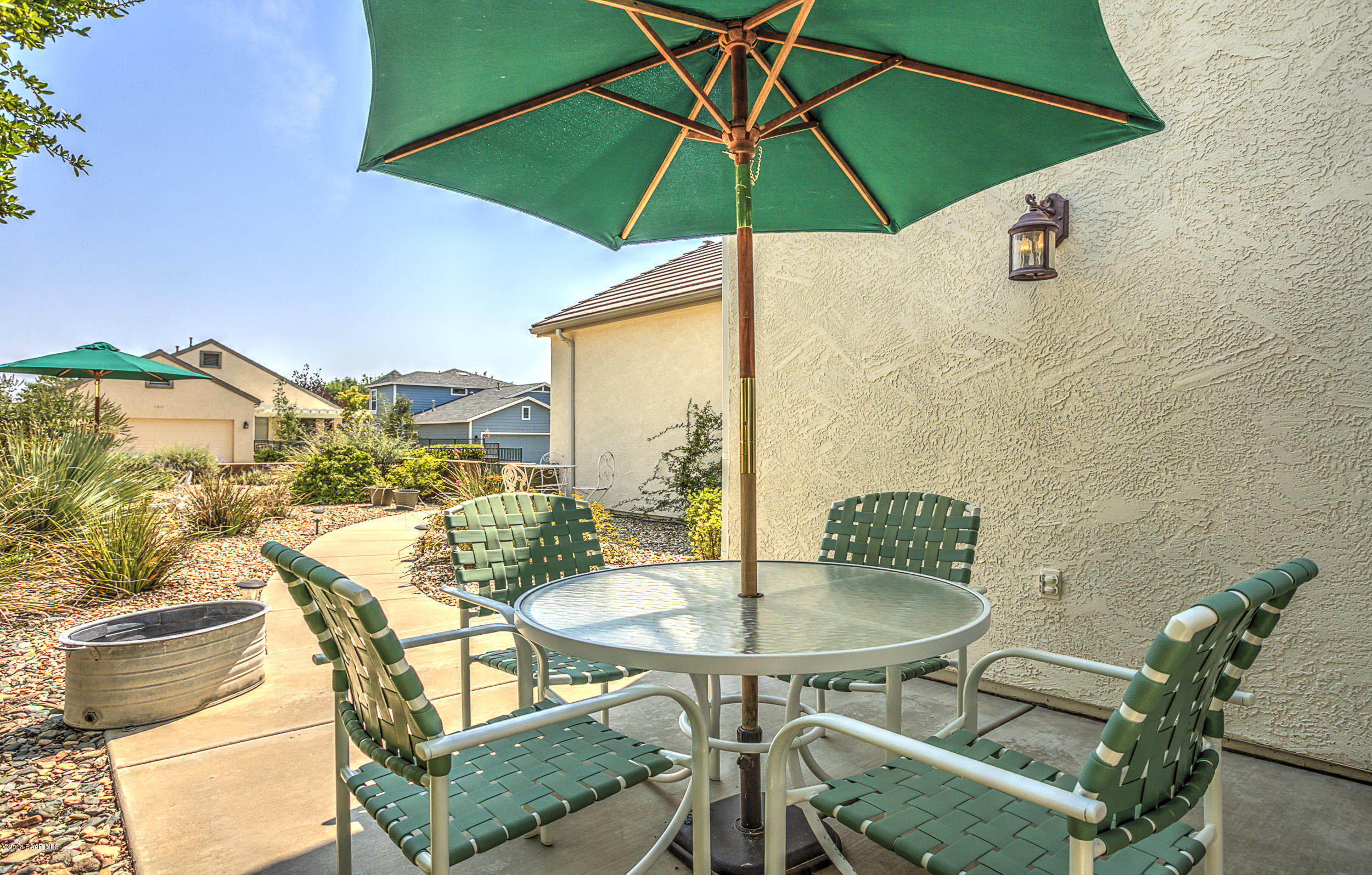 7106 Lynx Wagon Road Prescott Valley, AZ 86314 - Photo 16 of 26 a view of a patio with furniture and a umbrella