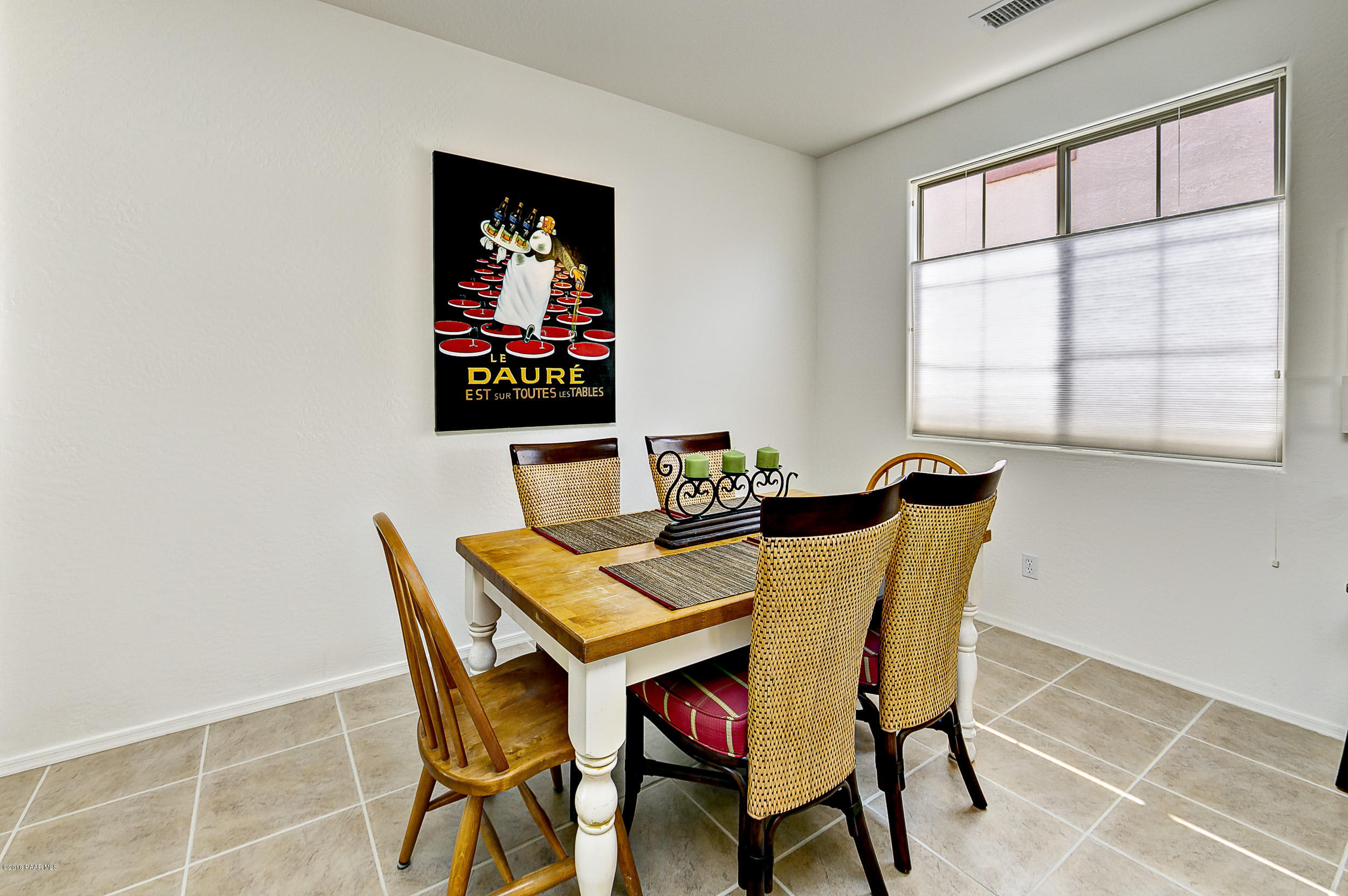 7106 Lynx Wagon Road Prescott Valley, AZ 86314 - Photo 7 of 26 a view of a dining room with furniture and wooden floor