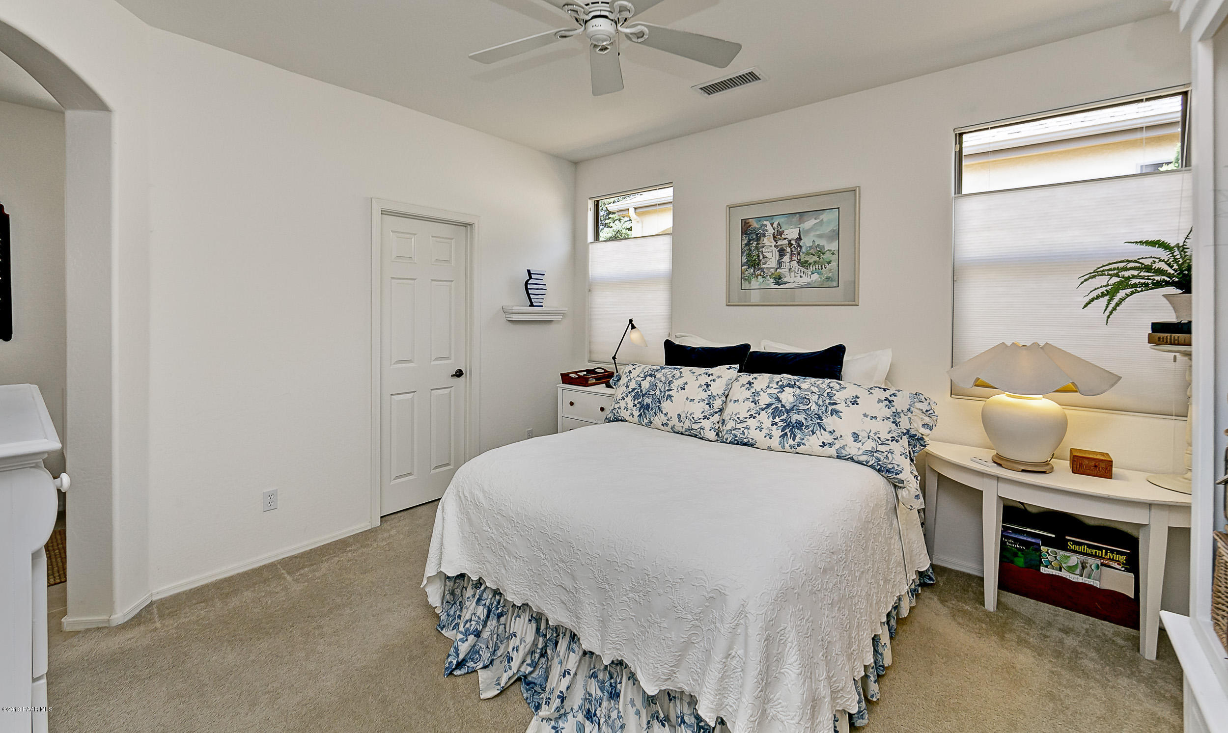 7106 Lynx Wagon Road Prescott Valley, AZ 86314 - Photo 8 of 26 a bedroom with a bed and a chandelier