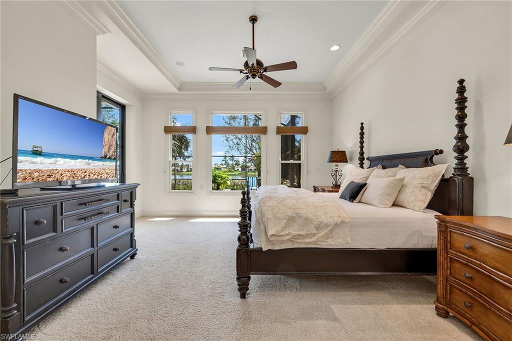 16839 Cabreo Drive Naples, FL 34110 - Photo 11 of 23 a spacious bedroom with a bed and a flat screen tv