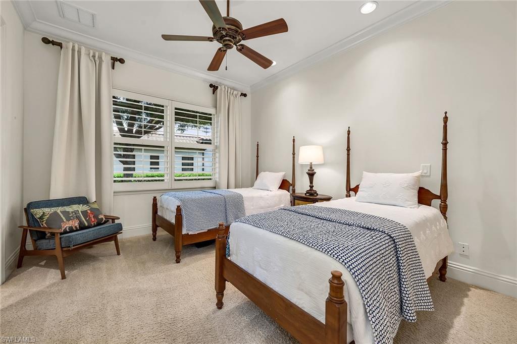 16839 Cabreo Drive Naples, FL 34110 - Photo 15 of 23 a bedroom with a bed couch and a window