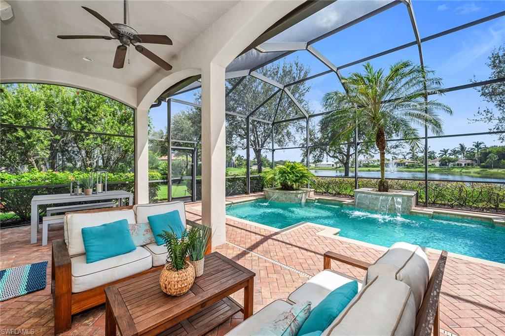 16839 Cabreo Drive Naples, FL 34110 - Photo 18 of 23 a view of a patio with couches potted plants and a big yard