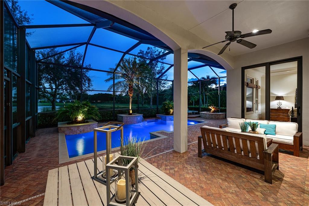 16839 Cabreo Drive Naples, FL 34110 - Photo 2 of 23 a view of a patio with a table chairs and a yard