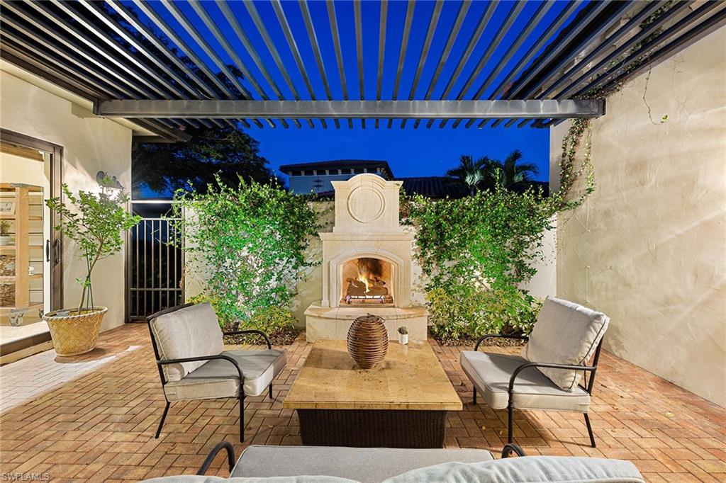 16839 Cabreo Drive Naples, FL 34110 - Photo 4 of 23 a front view of a house with outdoor seating