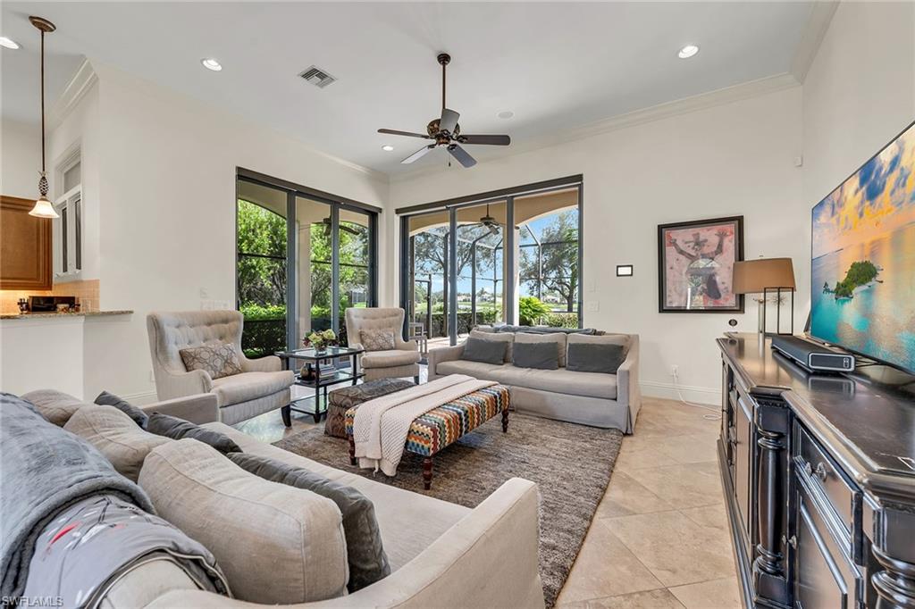 16839 Cabreo Drive Naples, FL 34110 - Photo 5 of 23 a living room with furniture flat screen tv and windows