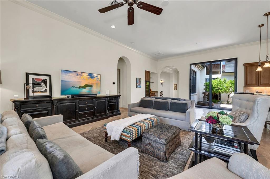 16839 Cabreo Drive Naples, FL 34110 - Photo 6 of 23 a living room with furniture and a flat screen tv