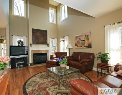 1100 Tullo Road Bridgewater, NJ 08836 - Photo 5 of 10 a living room with furniture a flat screen tv and a fireplace
