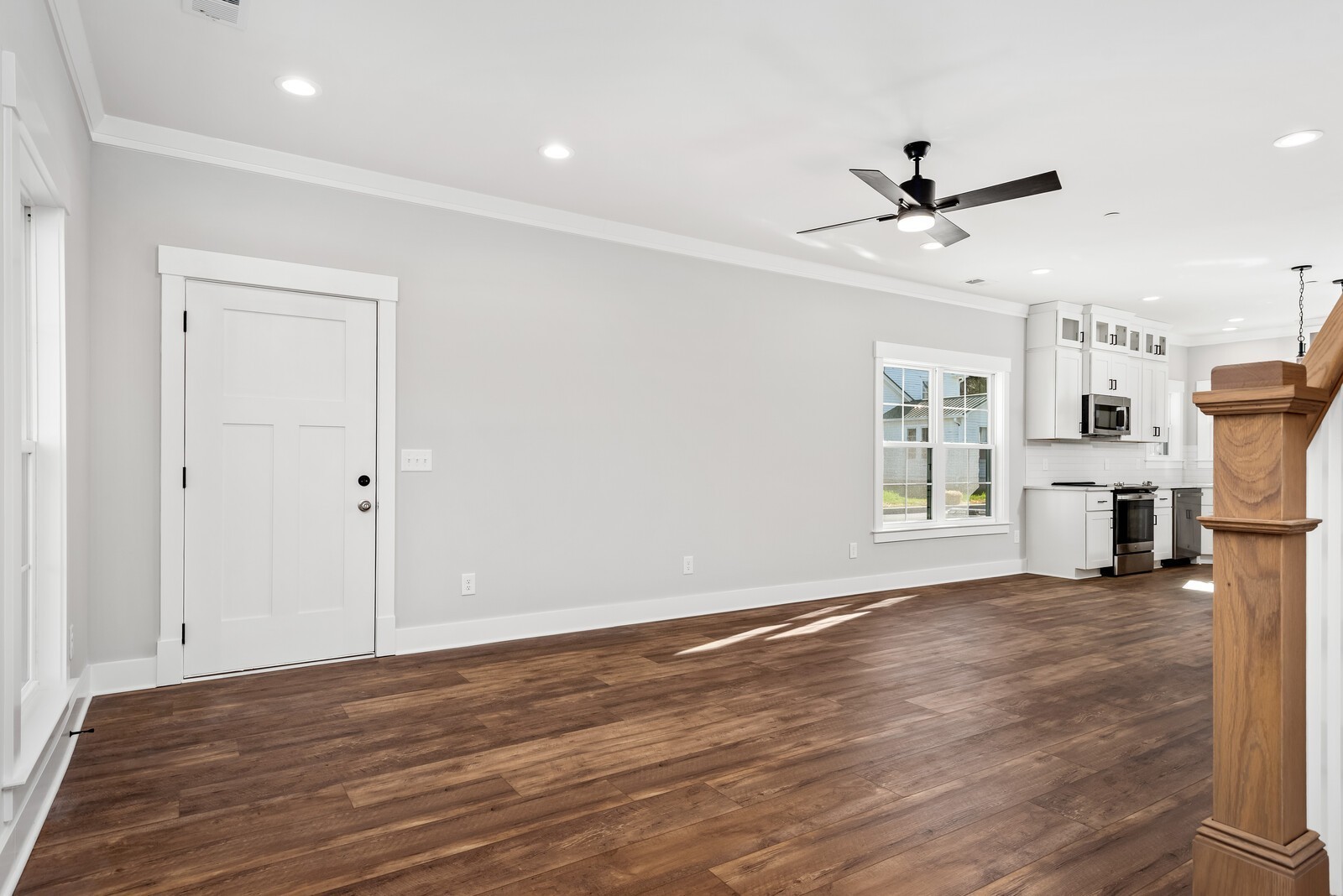 379 Beechcroft Road Spring Hill, TN 37174 - Photo 4 of 18 a view of a livingroom with a ceiling fan a fireplace and wooden floor
