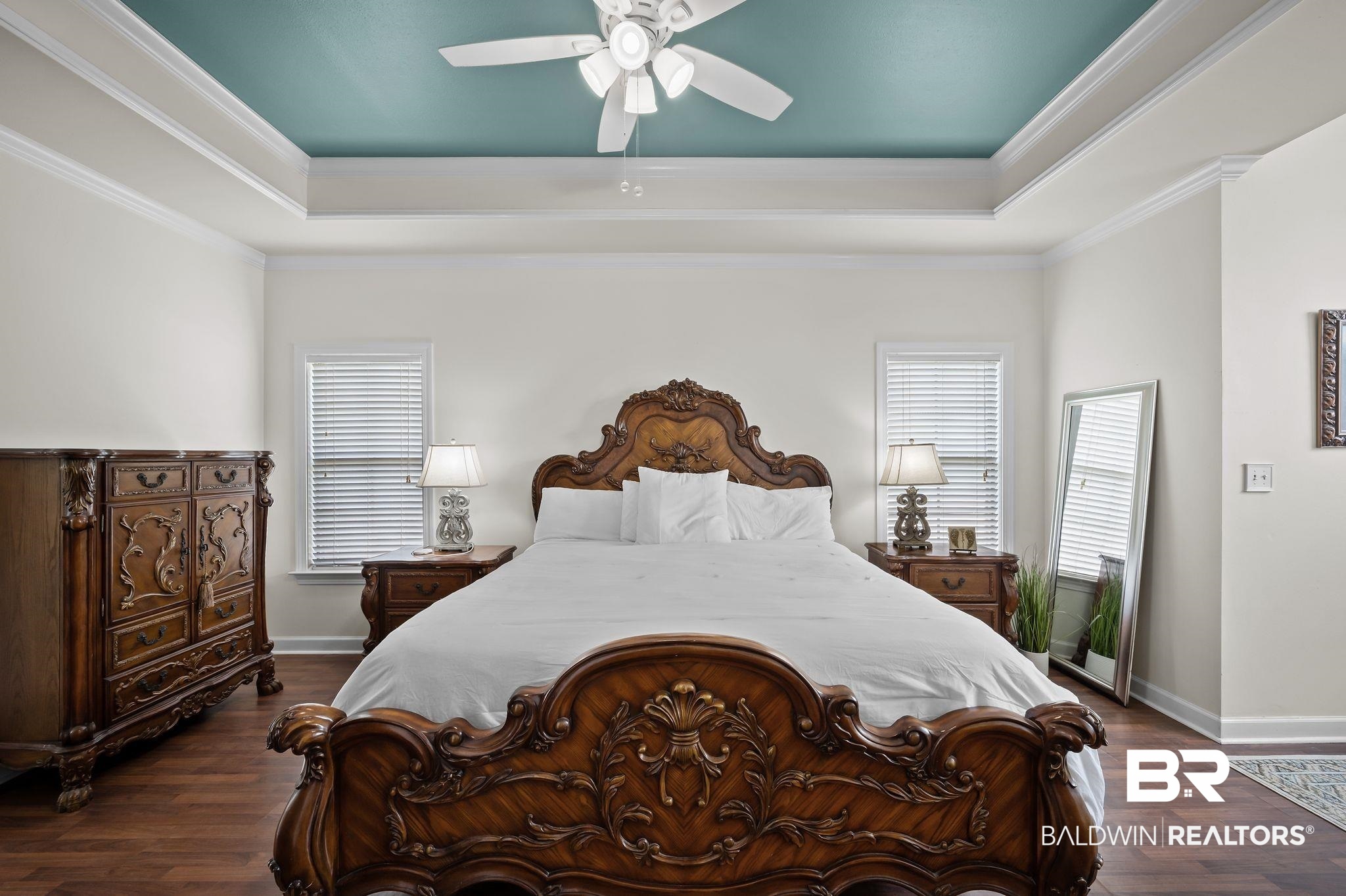 9837 Harmony Ridge Drive Semmes, AL 36575 - Photo 18 of 29 Bedroom featuring baseboards, dark wood finished floors, and a raised ceiling