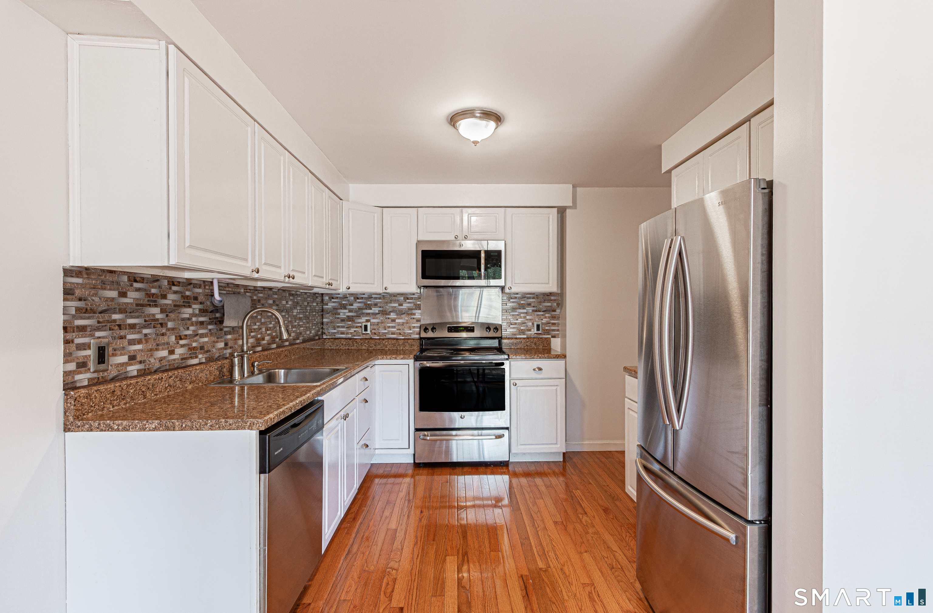 127 Old Farms Road, Unit 127 Torrington, CT 06790 - Photo 14 of 32 a kitchen with a refrigerator sink and microwave