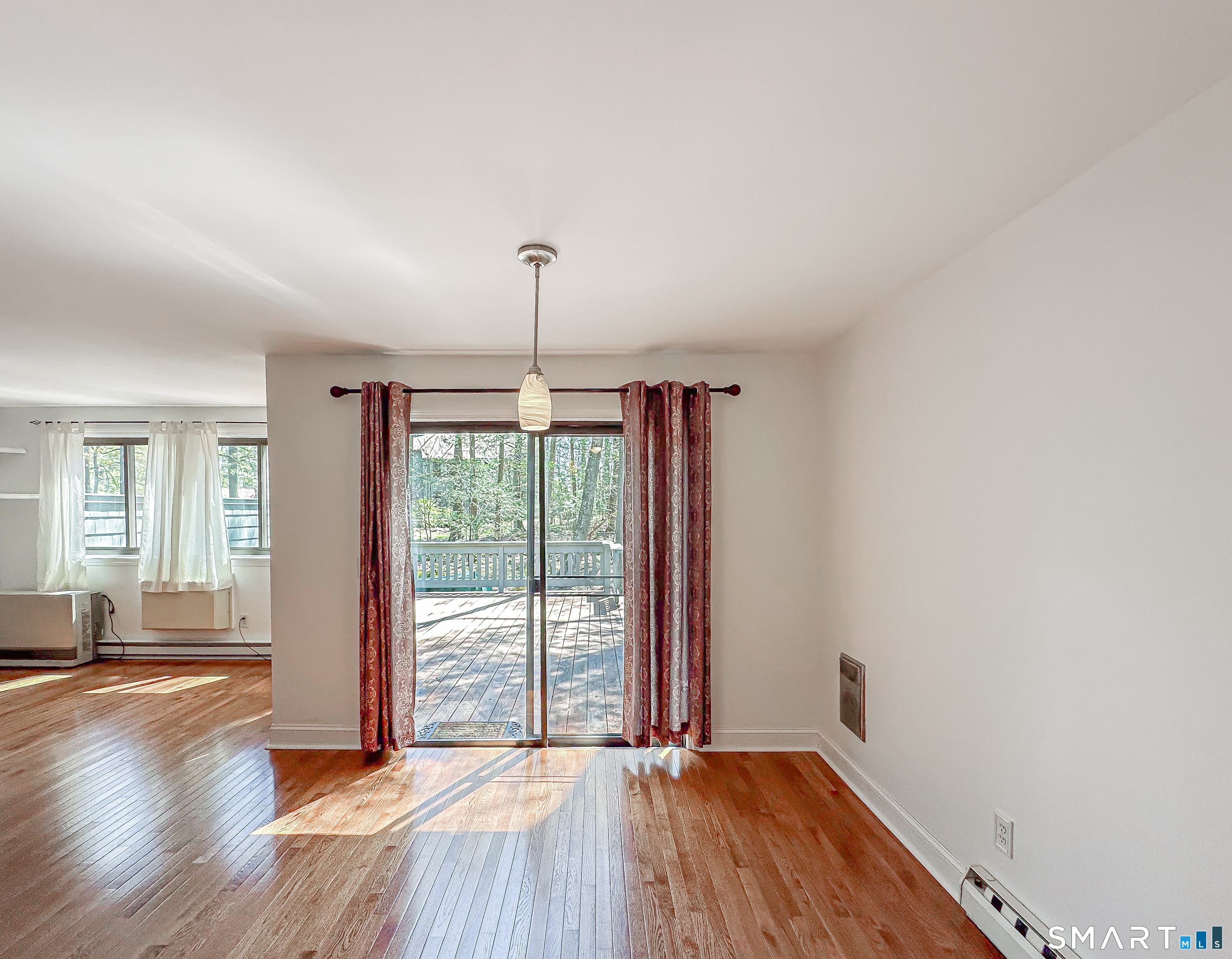 127 Old Farms Road, Unit 127 Torrington, CT 06790 - Photo 15 of 32 a view of empty room with wooden floor and fan