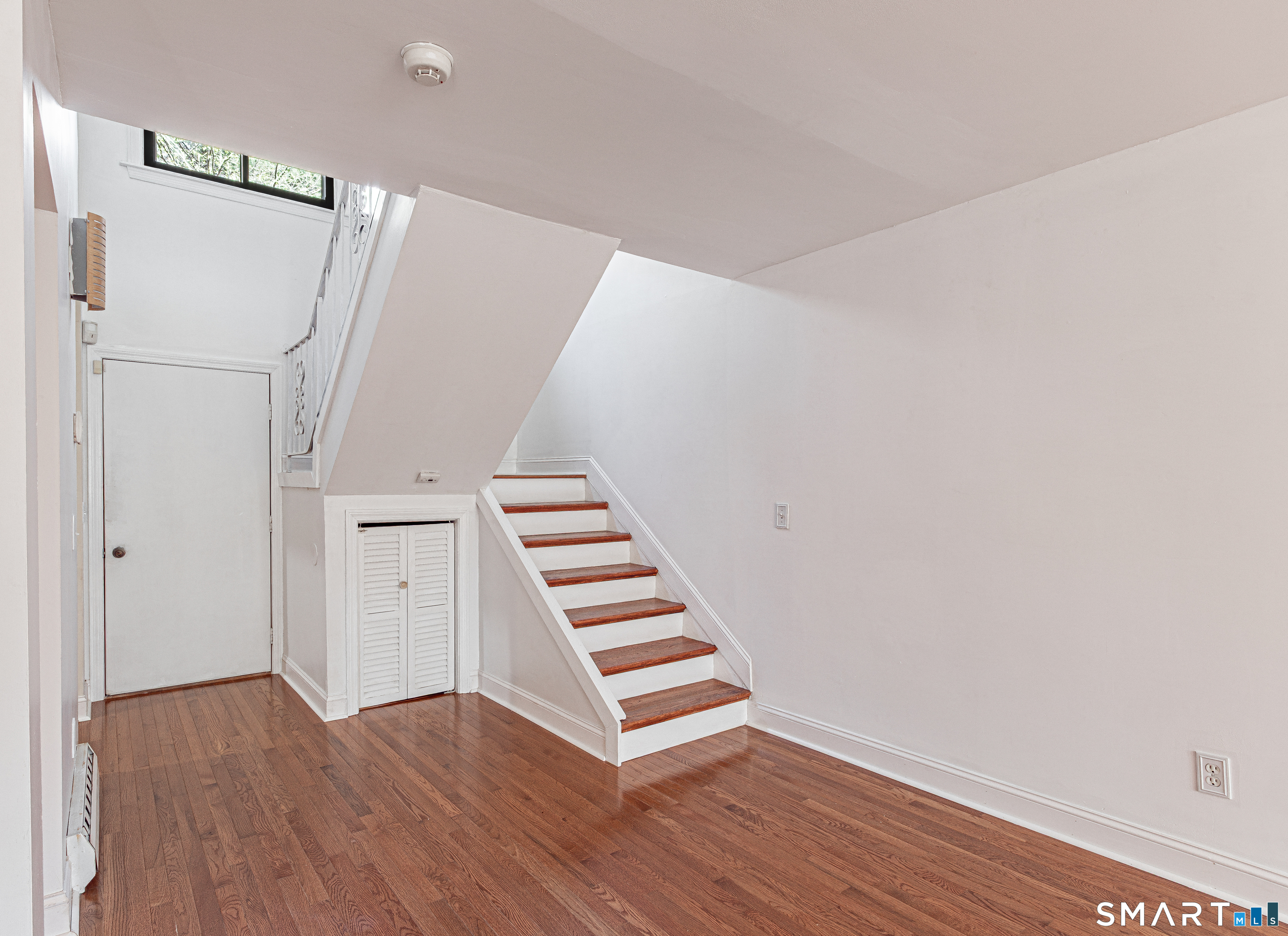 127 Old Farms Road, Unit 127 Torrington, CT 06790 - Photo 16 of 32 a view of hallway with stairs and wooden floor