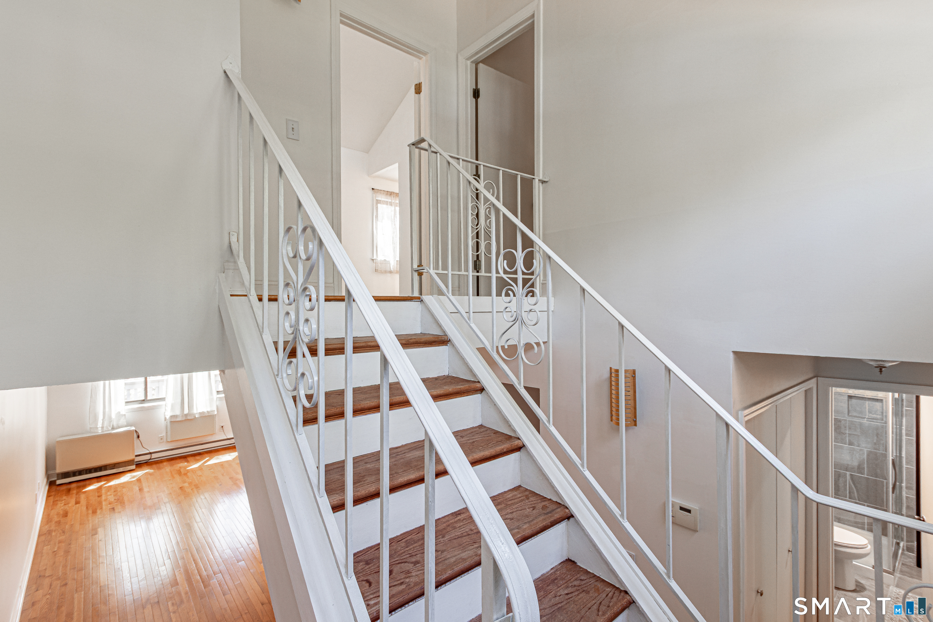 127 Old Farms Road, Unit 127 Torrington, CT 06790 - Photo 17 of 32 a view of staircase with wooden floor and white walls