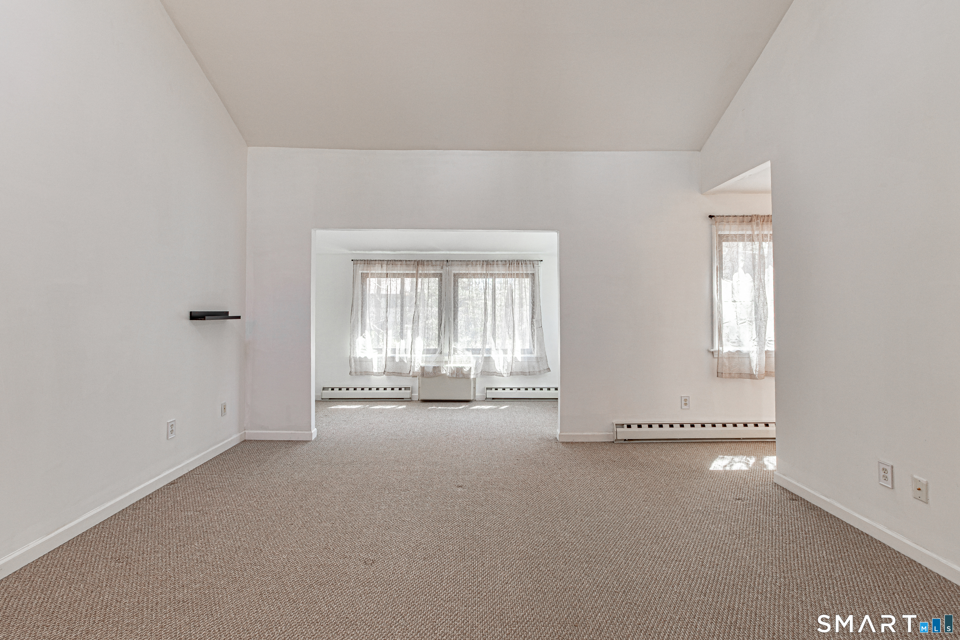 127 Old Farms Road, Unit 127 Torrington, CT 06790 - Photo 21 of 32 an empty room with a empty space and windows