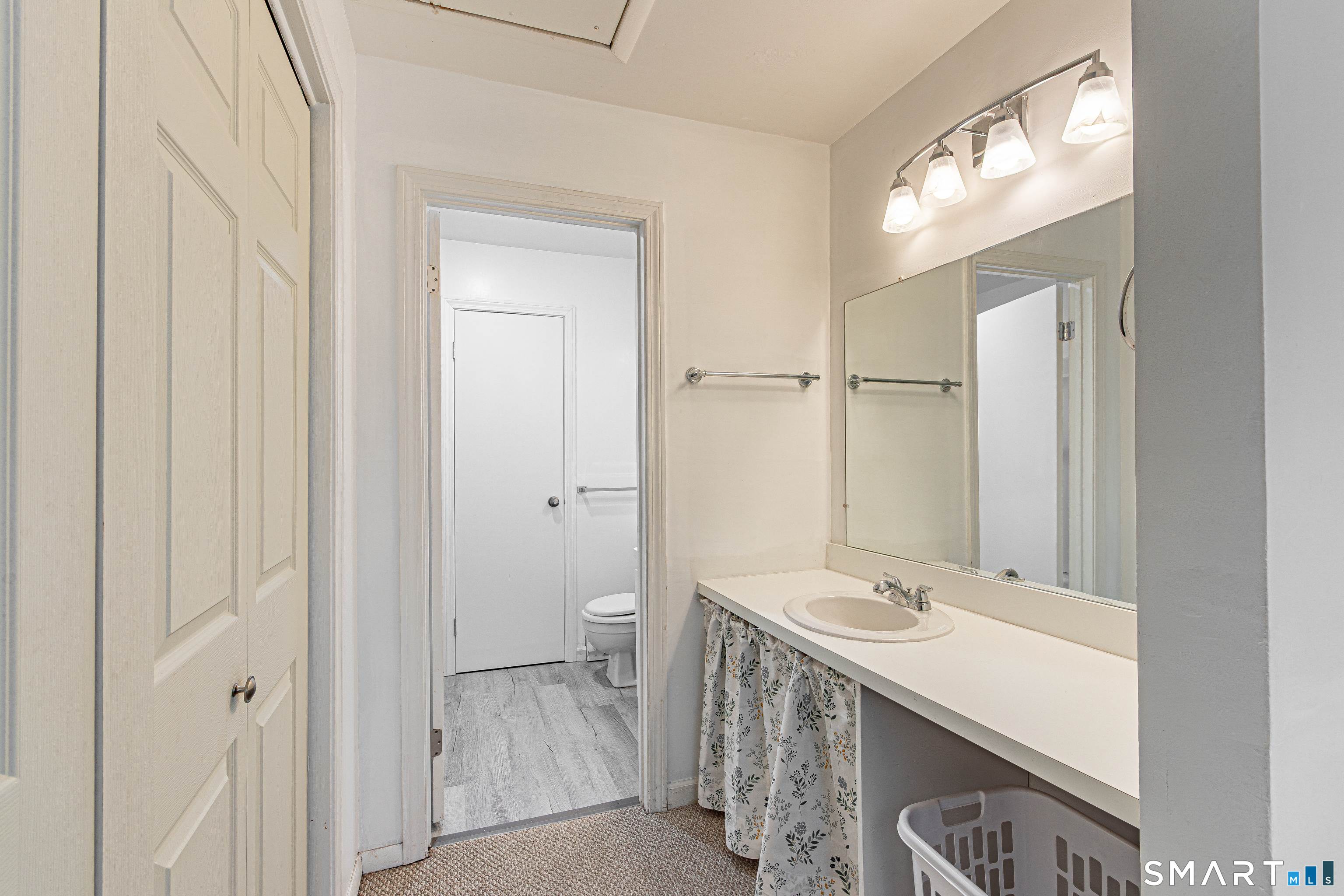 127 Old Farms Road, Unit 127 Torrington, CT 06790 - Photo 29 of 32 a bathroom with a sink and a mirror